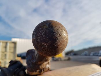 Close-up of a rusty, spherical metal object
