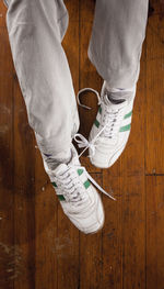 Low section of man on hardwood floor