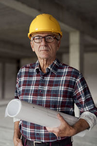 Portrait of smiling engineer standing at construction site