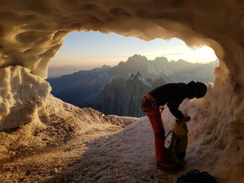 Man standing on mountain against sky