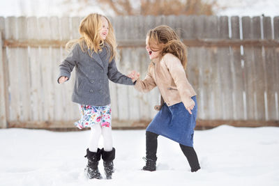 Full length of girl standing on snow