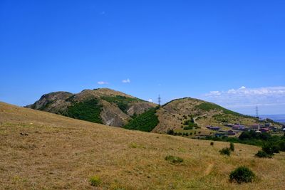 Scenic view of mountains against clear blue sky