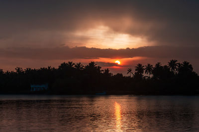 Scenic view of lake against orange sky