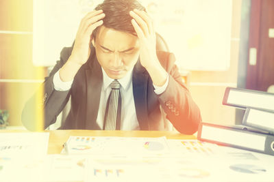 Midsection of man sitting on table