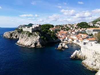 View of townscape by sea against sky