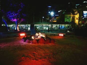 People in illuminated city at night