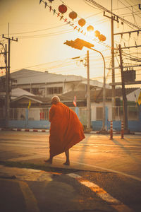 Rear view of man in city against clear sky