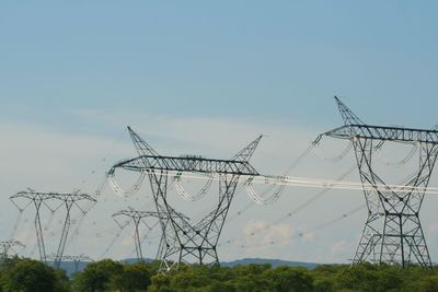 Low angle view of electricity pylon against sky