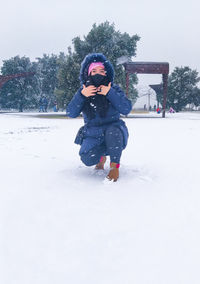 Full length of child on snow covered field during winter