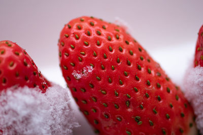 Close-up of strawberry over white background