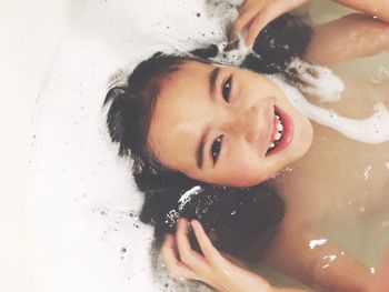 Portrait of young woman in bathtub