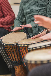 Midsection of man playing drum