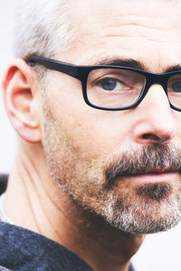 Close-up portrait of man wearing eyeglasses