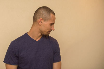 Mid adult man standing against wall