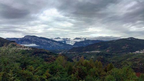 Scenic view of mountains against cloudy sky