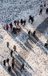 High angle view of people walking on road