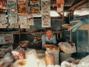 Man for sale at market stall