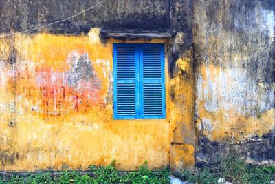 Close-up of blue window on wall