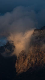Smoke emitting from volcanic mountain against sky