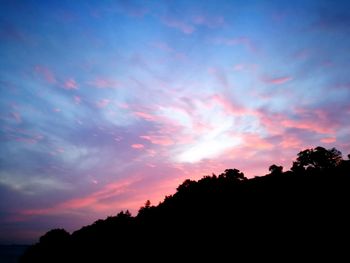 Low angle view of silhouette trees against sky during sunset