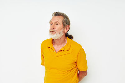 Portrait of young man standing against white background