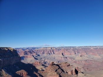 Scenic view of the grand canyon against a clear blue sky. 