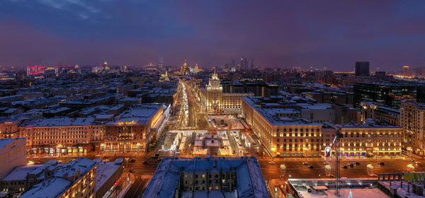 High angle view of city lit up at night