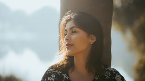 Portrait of beautiful young woman looking away