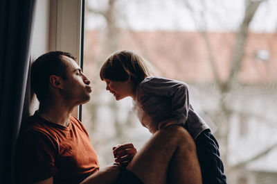 Side view of couple kissing outdoors