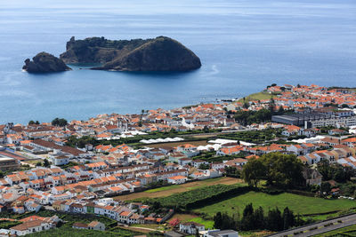 High angle view of townscape by sea