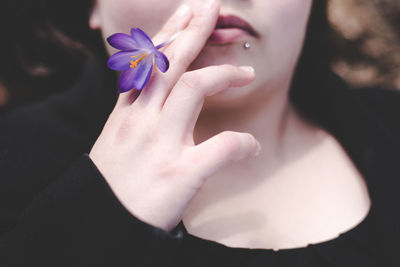 Cropped image of woman holding crocus