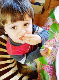 Portrait of cute boy holding food