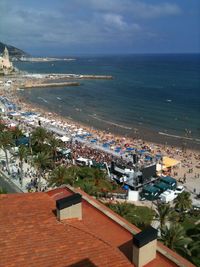 High angle view of townscape by sea against sky