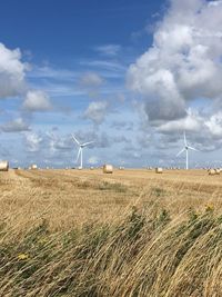 Windmill on field against sky