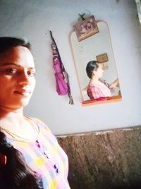 Portrait of cute girl with pink painting on wall