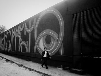 Low angle view of woman standing by railing