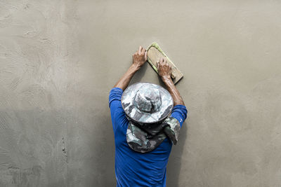 Rear view of mason working at construction site