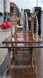 Empty chairs and tables at sidewalk cafe in rainy season