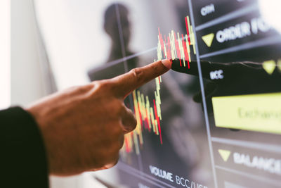 Cropped hand of man using mobile phone