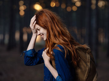 Beautiful woman standing against blurred background