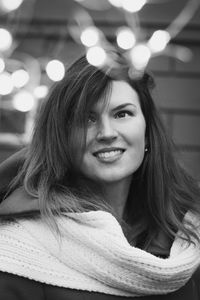 Close up happy woman with fairy lights monochrome portrait picture