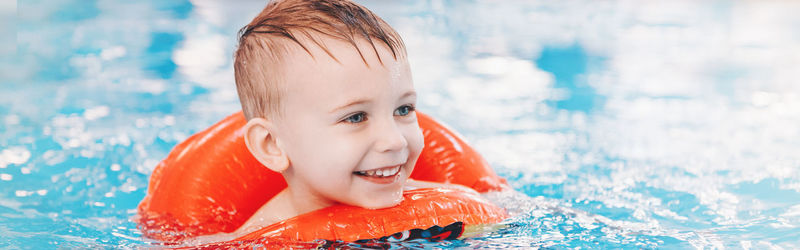 Smiling cute boy in swimming pool