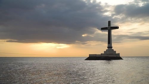 Sunken cemetery cross in camiguin island. large crucafix marking the underwater sunken cemetary