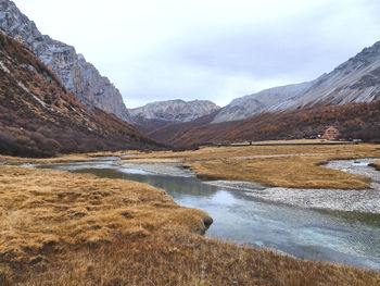 Scenic view of lake and mountains against sky