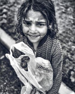 Portrait of smiling girl holding outdoors