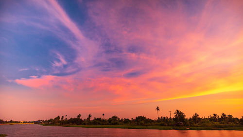 Scenic view of field against romantic sky at sunset