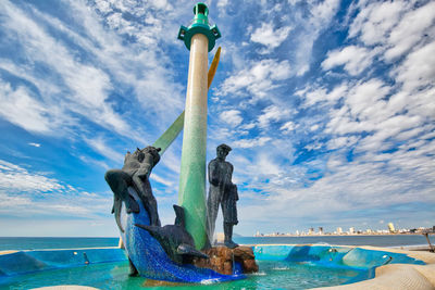 Statue of sea against cloudy sky