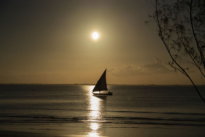 Sailboat on sea against sky during sunset