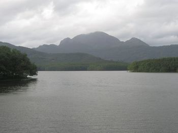 Scenic view of river and mountains against sky