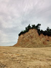 Scenic view of rocks on field against sky